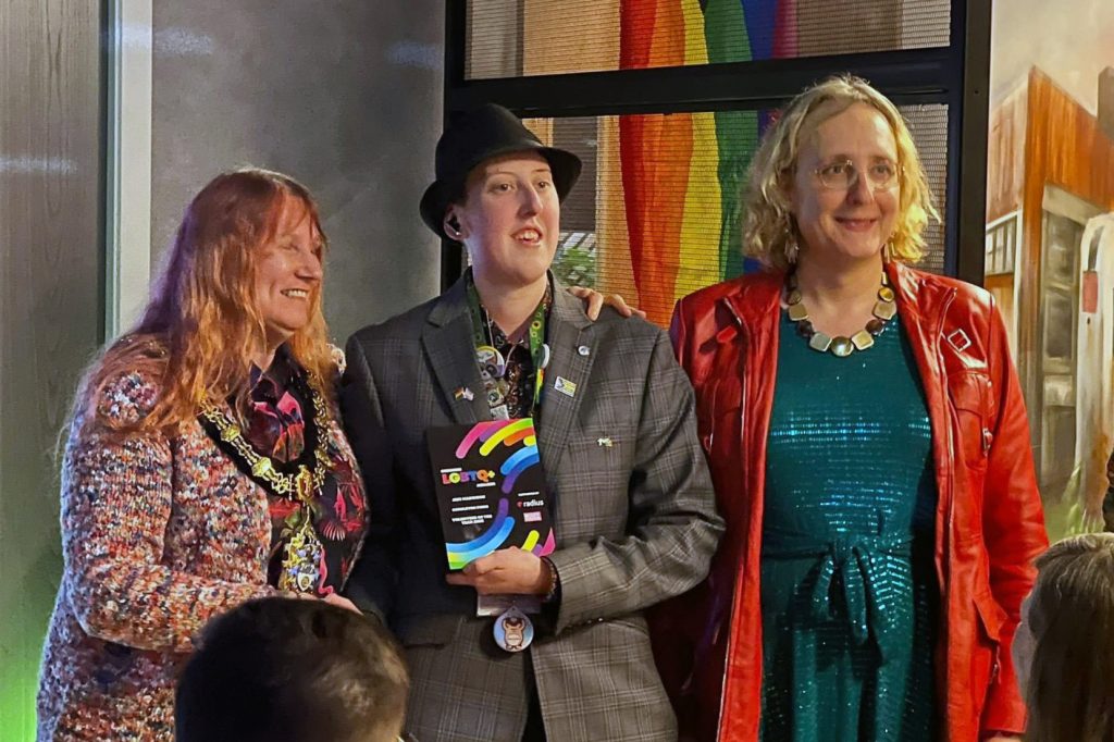 Jess Maddison (centre) receiving volunteer award
