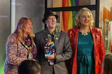 Jess Maddison (centre) receiving volunteer award